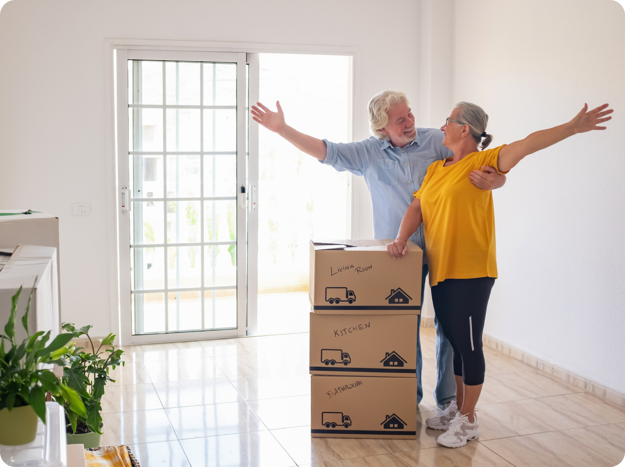 Happy senior couple unpacking boxes in new home.